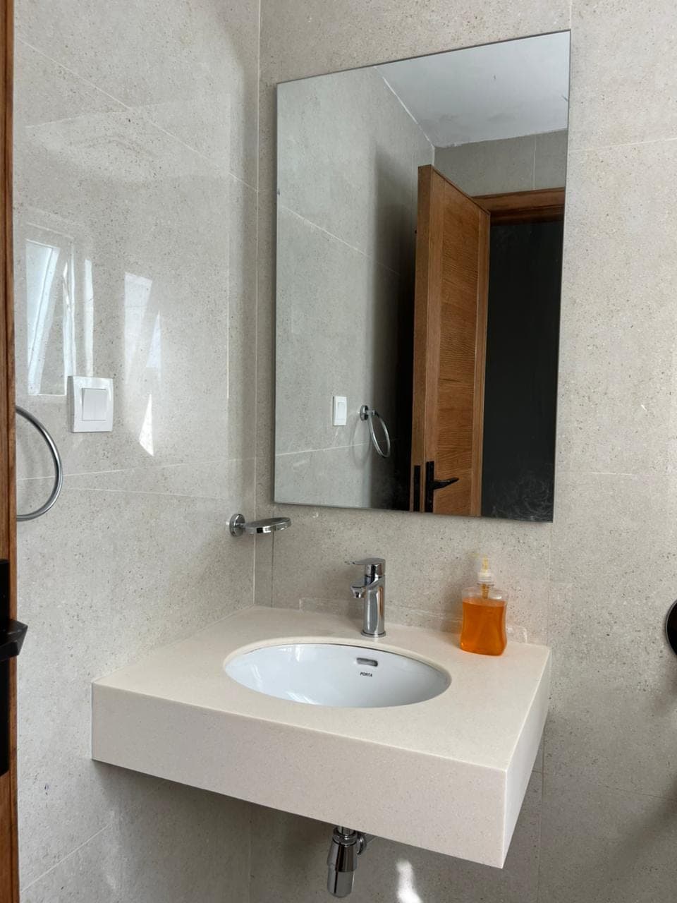 Floating stone basin, mirror and chrome fittings in the hotel room en-suite at MYG Nathiagali