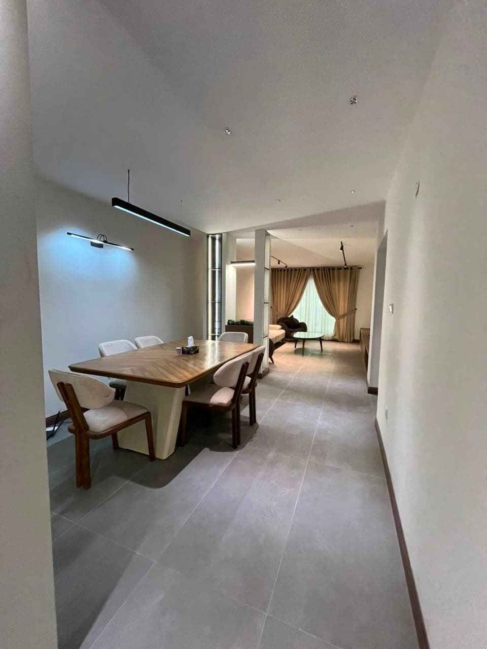 Dining room opening onto the lounge in a finished MYG Nathiagali apartment near Abbottabad, Galiyat