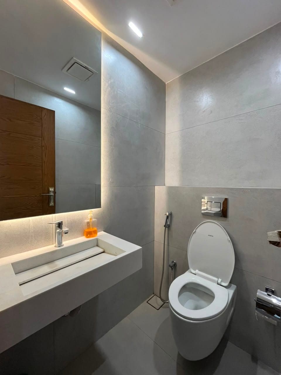 Guest washroom with stone trough basin and wall-hung WC in the three-bedroom apartment at MYG Nathiagali