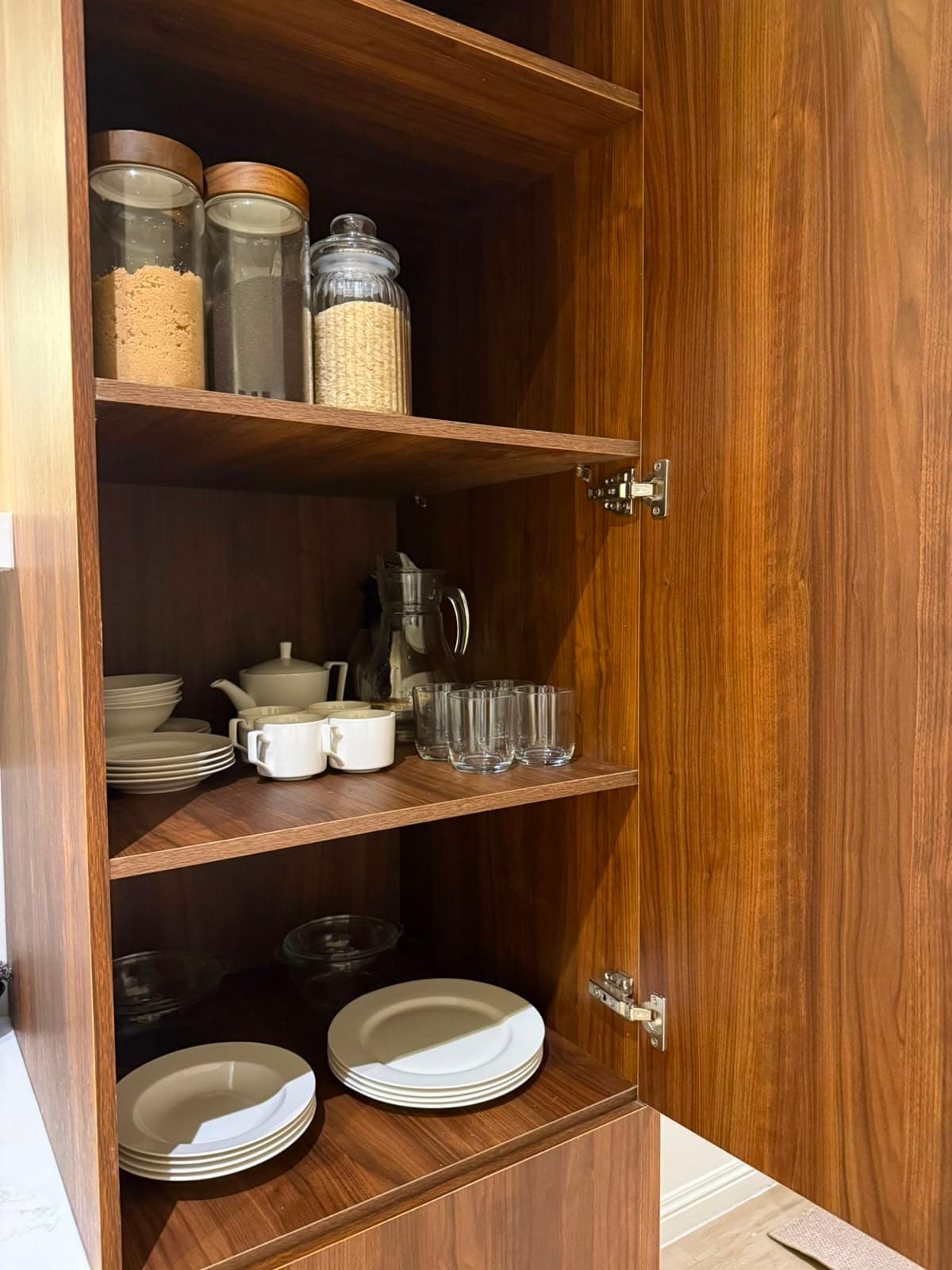 Stocked crockery and glassware cupboard in the serviced attic apartment at MYG Nathiagali