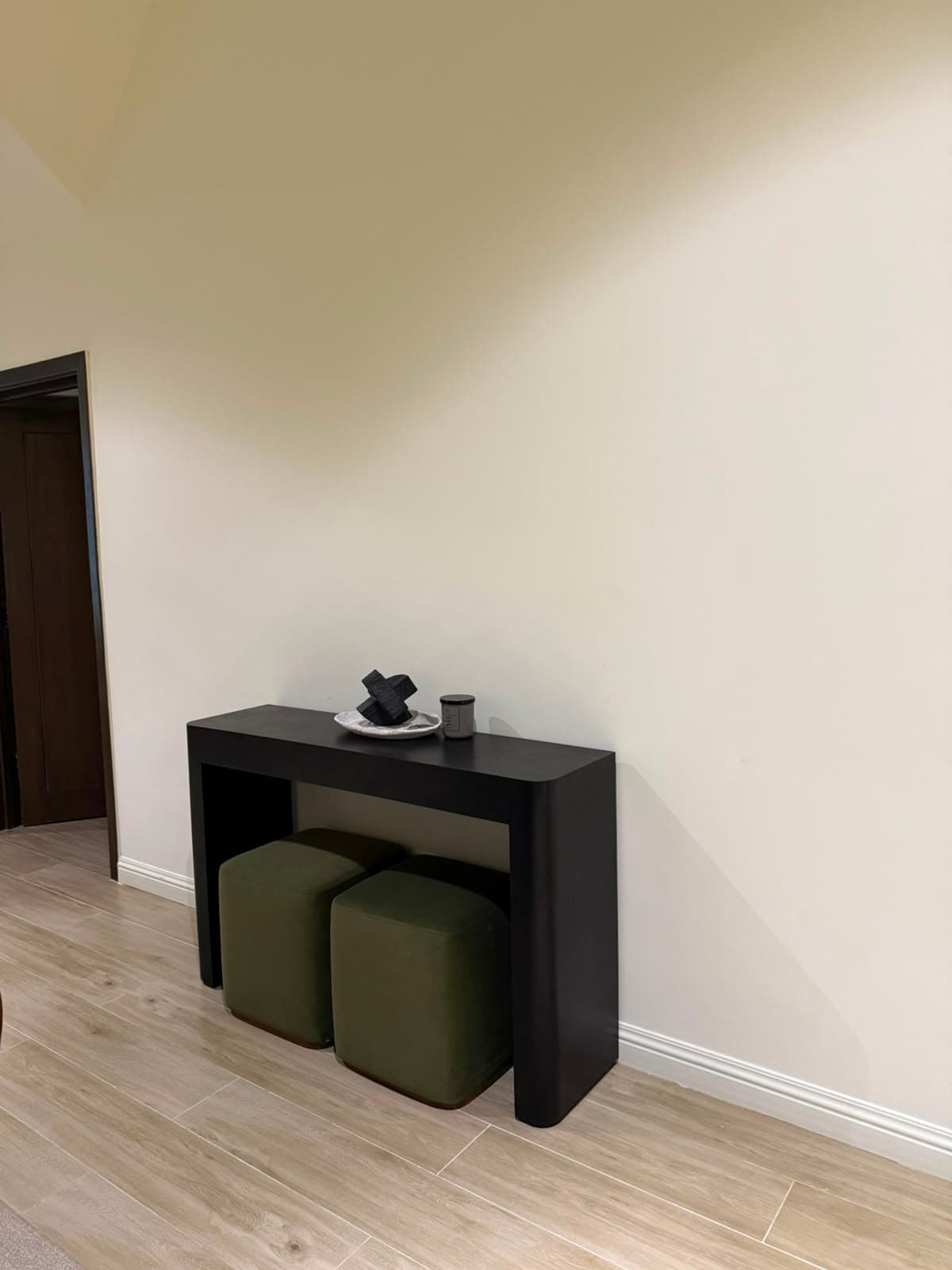 Entry console with stools on wood flooring in the attic apartment at MYG Nathiagali