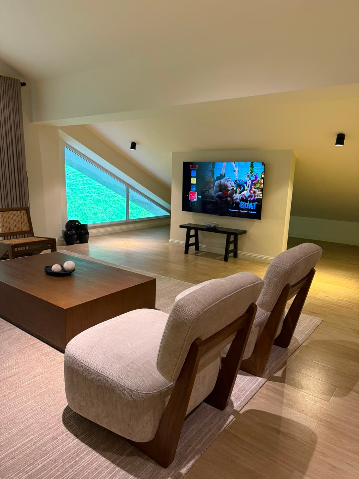 Attic TV den with smart TV and angled forest window at MYG Nathiagali serviced stays