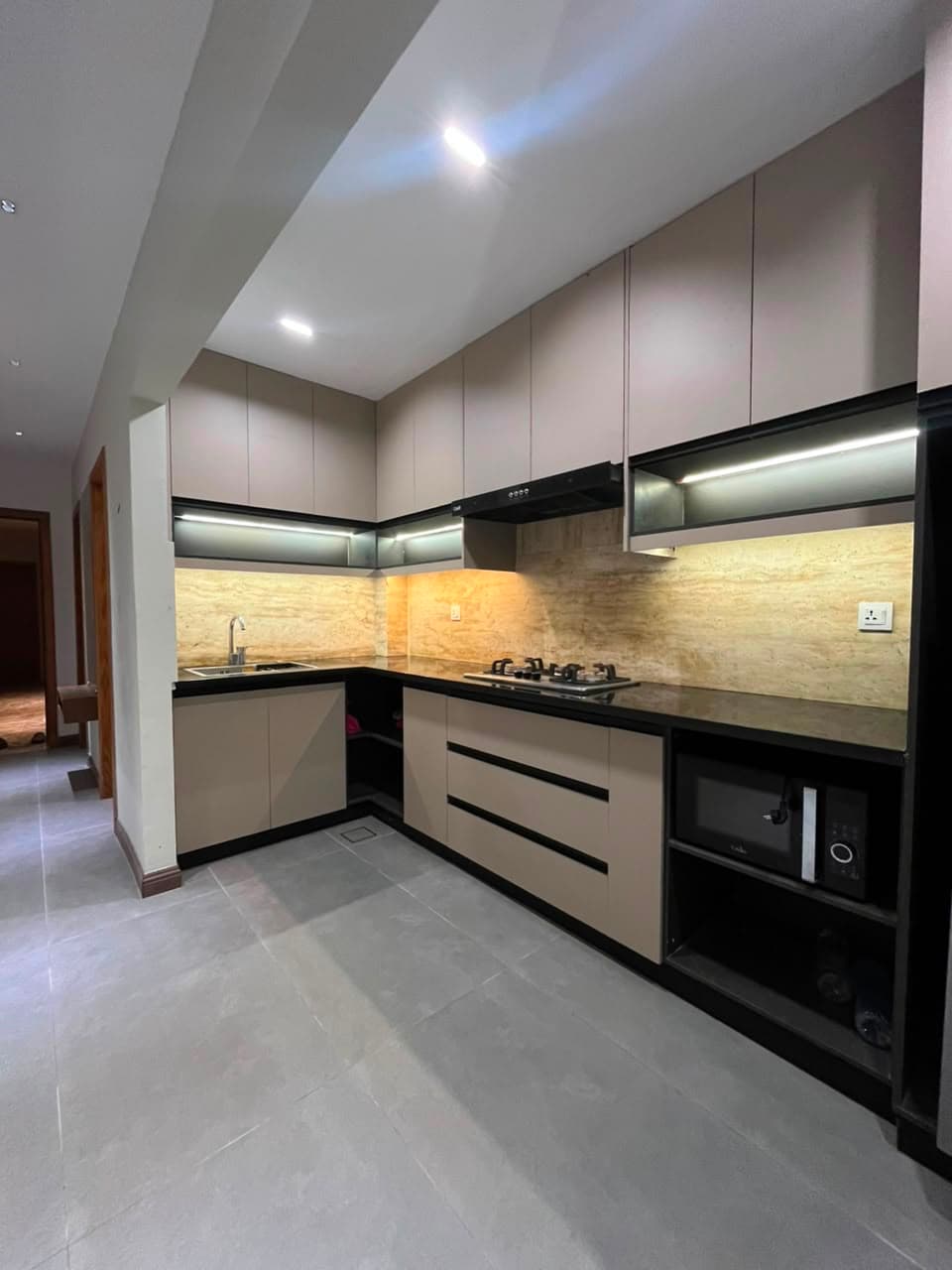 Hallway with fridge and fitted storage in a serviced apartment in Nathiagali